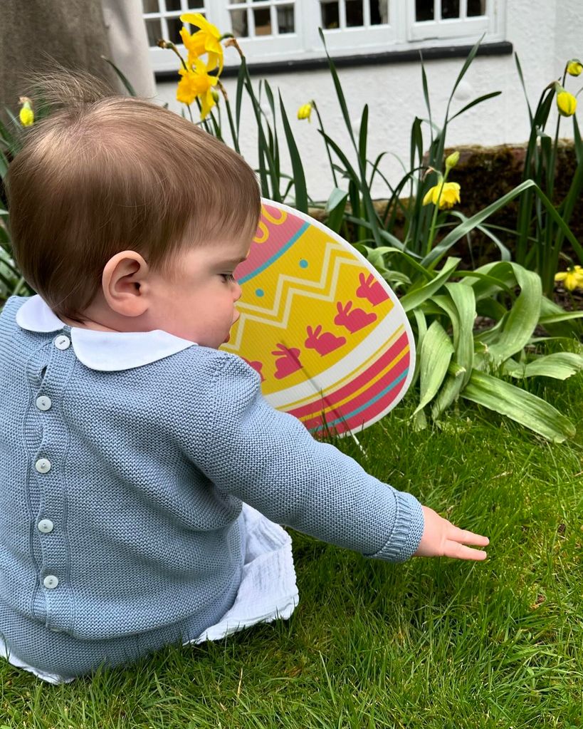 Ernest Brooksbank on grass in blue cardigan