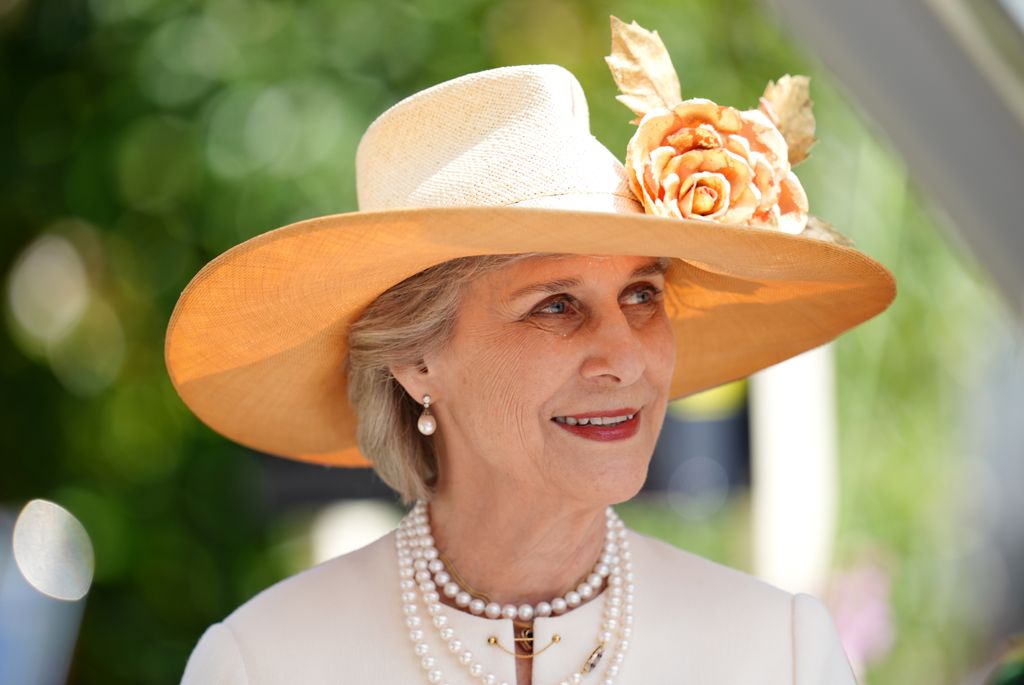 The Duchess of Gloucester wearing cream coat, pearls and floral hat at Royal Ascot