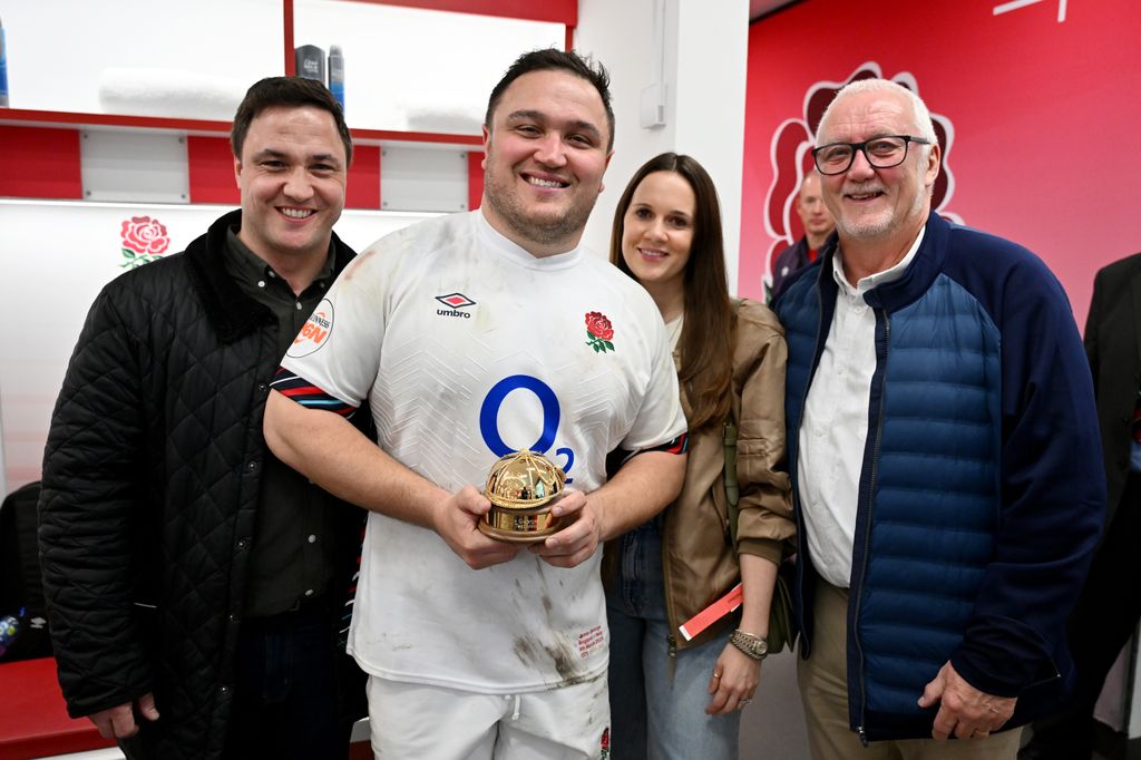 Jamie George with Katie George, his brother and father