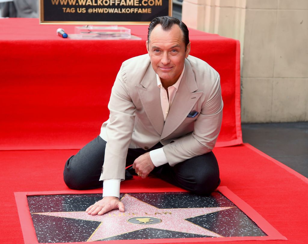 Jude Law poses with his star during the Jude Law Star Ceremony on Hollywood Boulevard