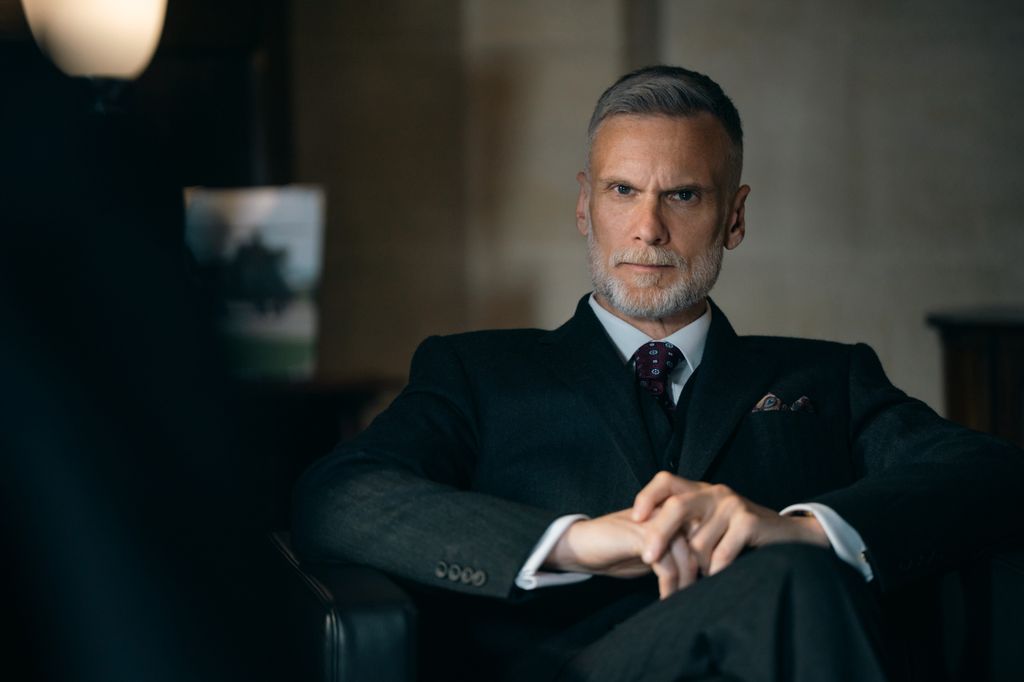 man in suit sitting in chair