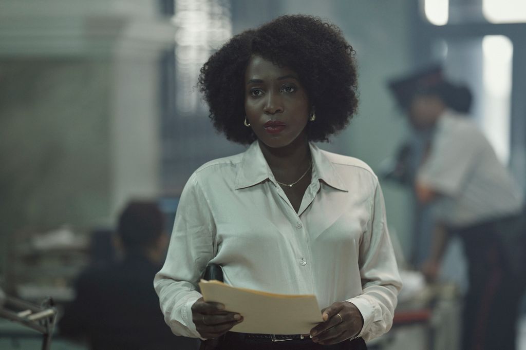 Woman in white shirt holding papers