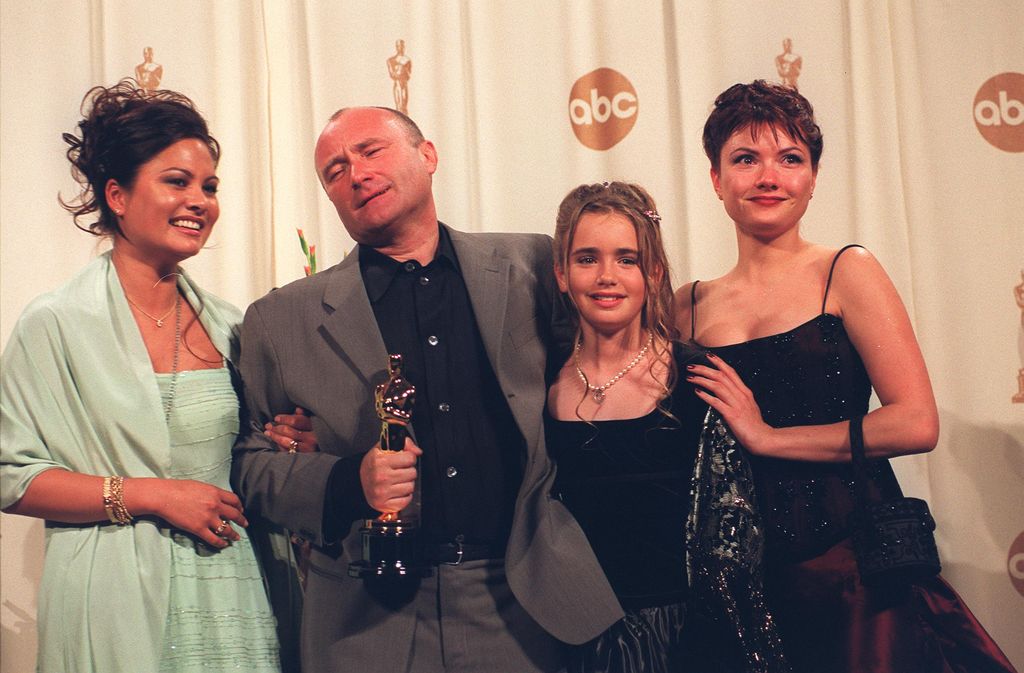 Phil Collins and a young Lily Collins with two women