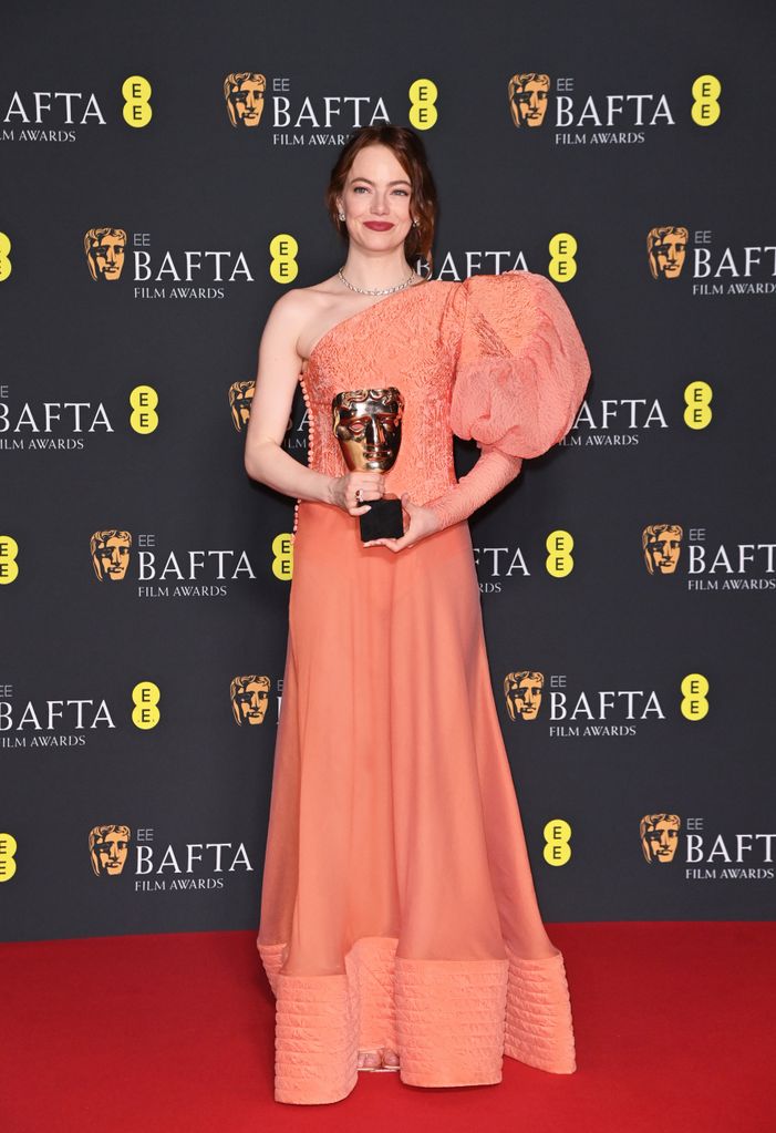 Emma Stone poses with the Leading Actress Award in the winners room during the 2024 EE BAFTA Film Awards
