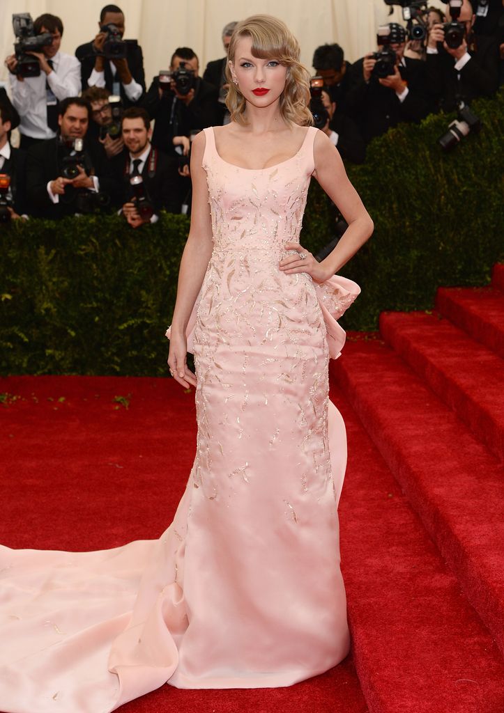 Taylor Swift wore a pink embroidered Oscar de la Renta dress with a train to Met Gala 2014.