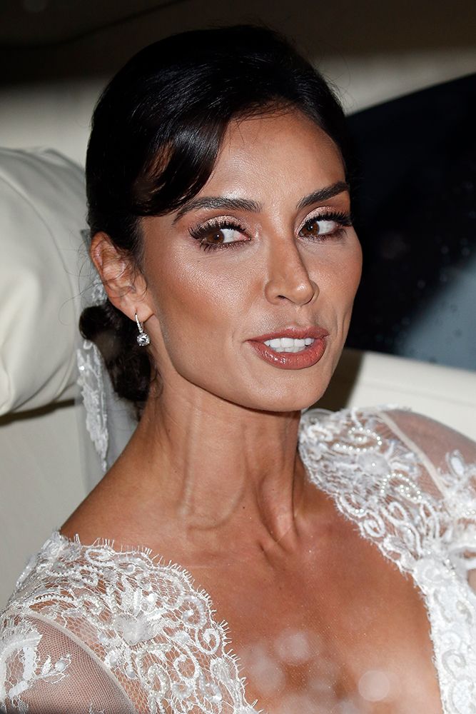 Christine Lampard wearing a long-sleeved lace bridal gown by Suzanne Neville