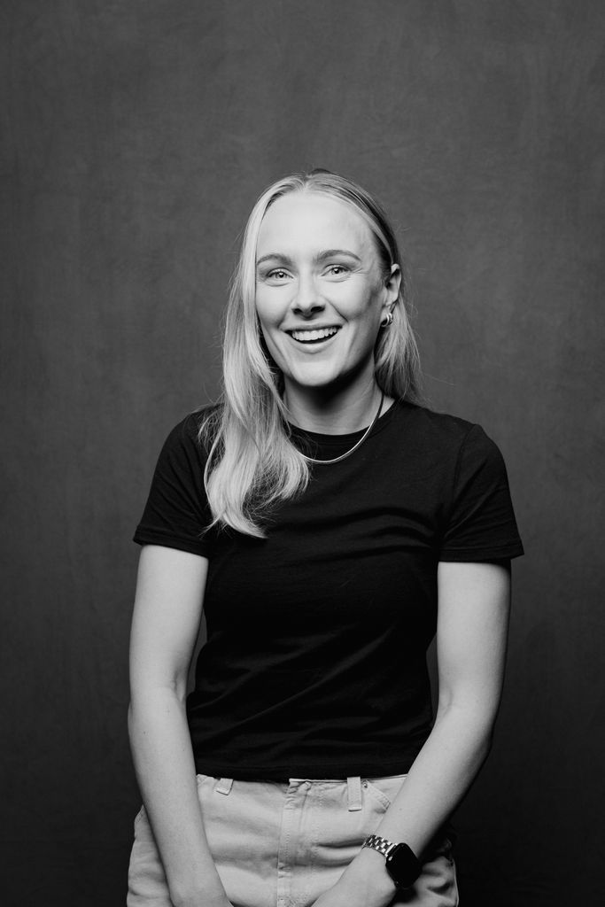 Josie smiling in black and white headshot