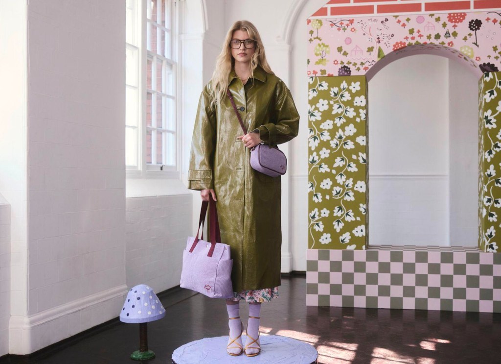 model in green coat with purple bag