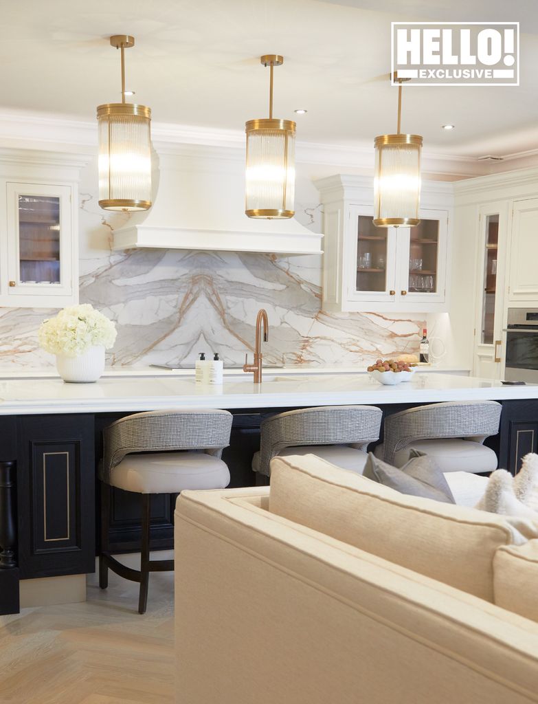 Jessica Wright new kitchen with gold hanging lamps and grey marble backsplash