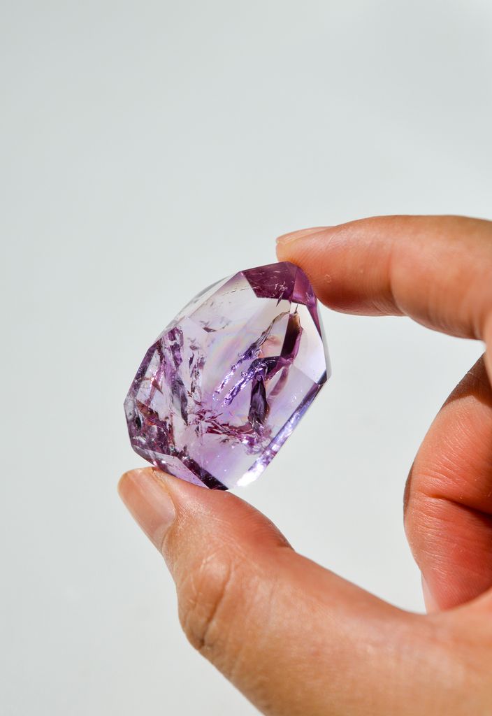 hand holding amethyst crystal