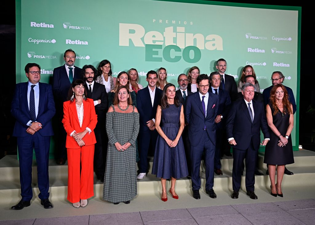 Queen Letizia poses with people at event