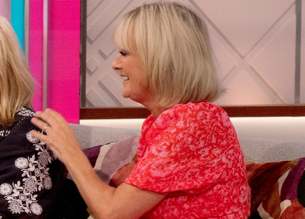 Jane Moore wearing a pink dress and her wedding ring on Loose Women