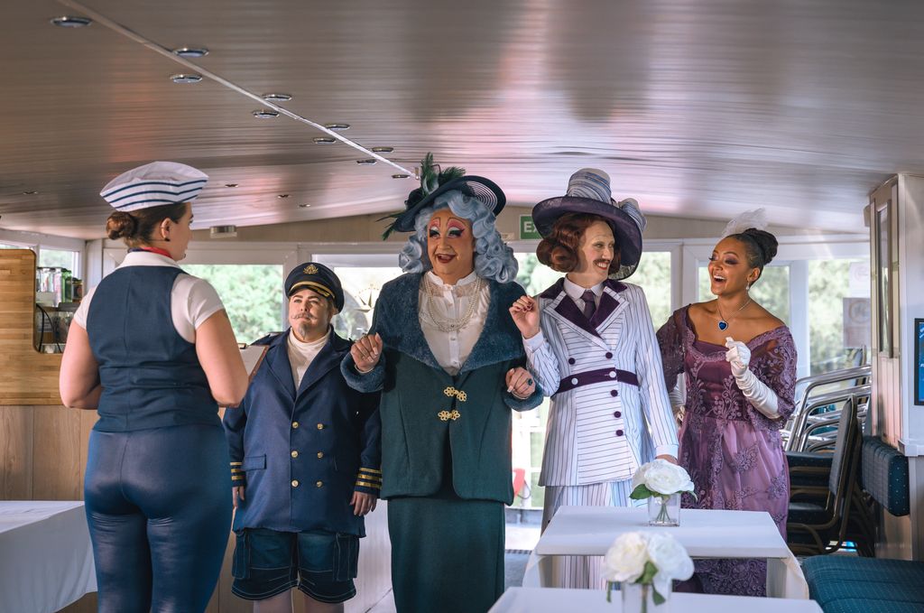 group of people in dresses standing in room