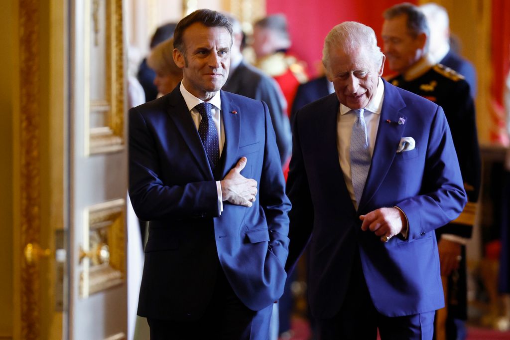 French President Emmanuel Macron alongside Britain's King Charles III arrives to view an exhibition of art from the Royal Collection exhibition, in the Green Drawing Room at Windsor Castle