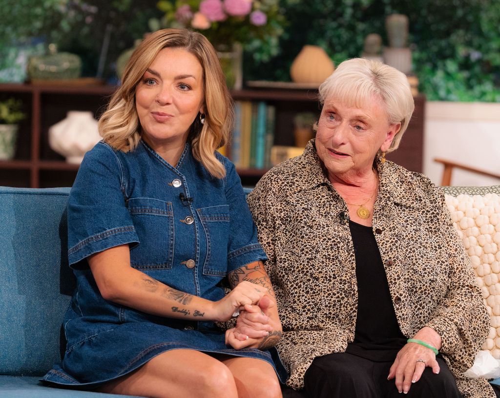 woman and older woman sitting on sofa in tv studio