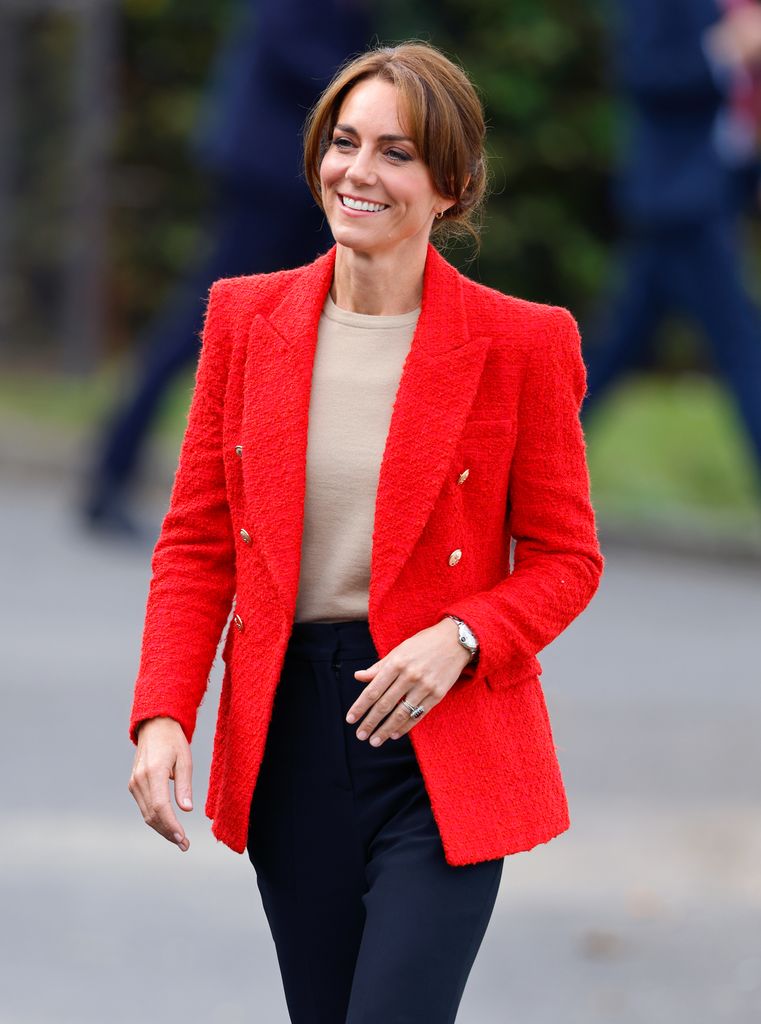 Kate Middleton, Princess of Wales wears a red blazer in Sittingbourne, England. 