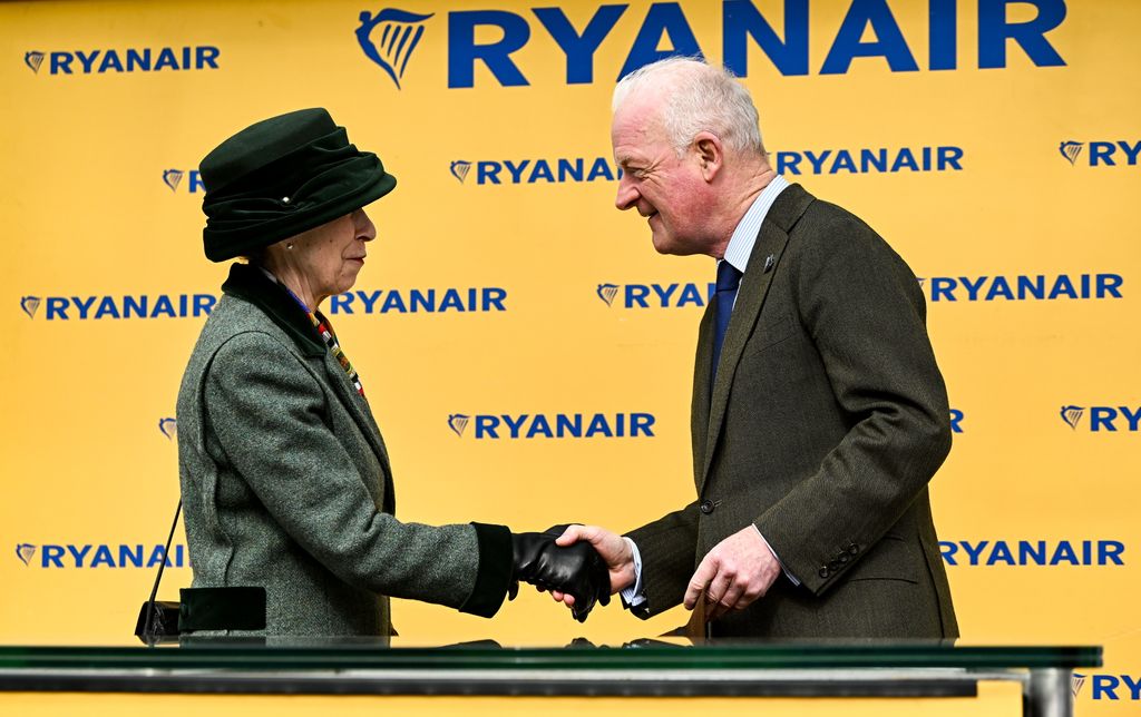 Princess Anne, Princess Royal, presents trainer Willie Mullins with a framed print to mark his hundreth Cheltenham winner on day three of the Cheltenham Racing Festival 