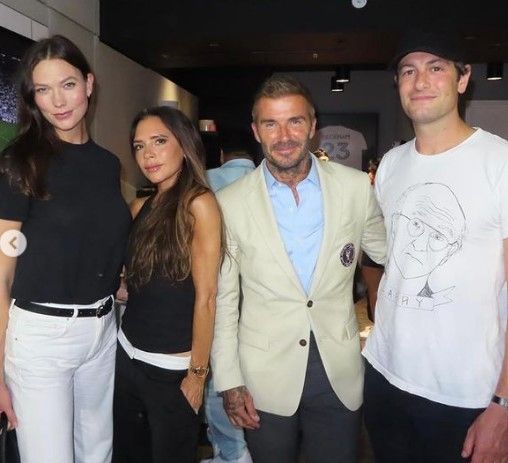 Karlie Kloss posing with Victoria and David Beckham and Josha Kushner