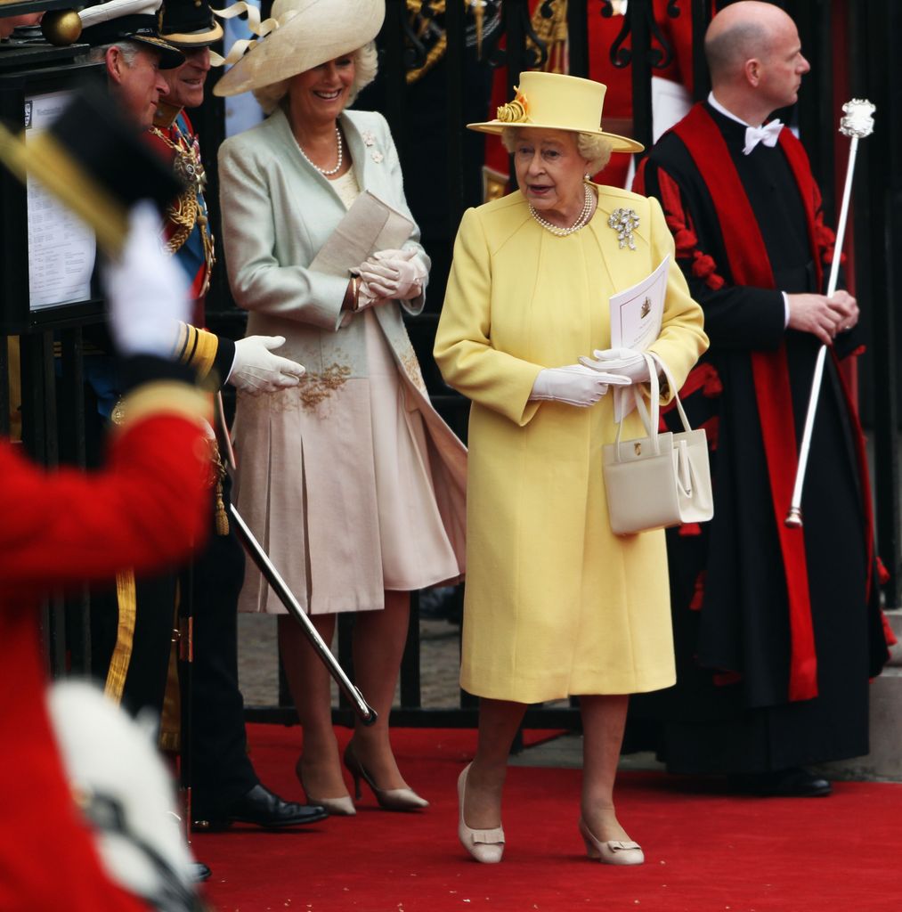 Queen Elizabeth II wearing a yellow coat dress by Angela Kelly at William and Kate's wedding
