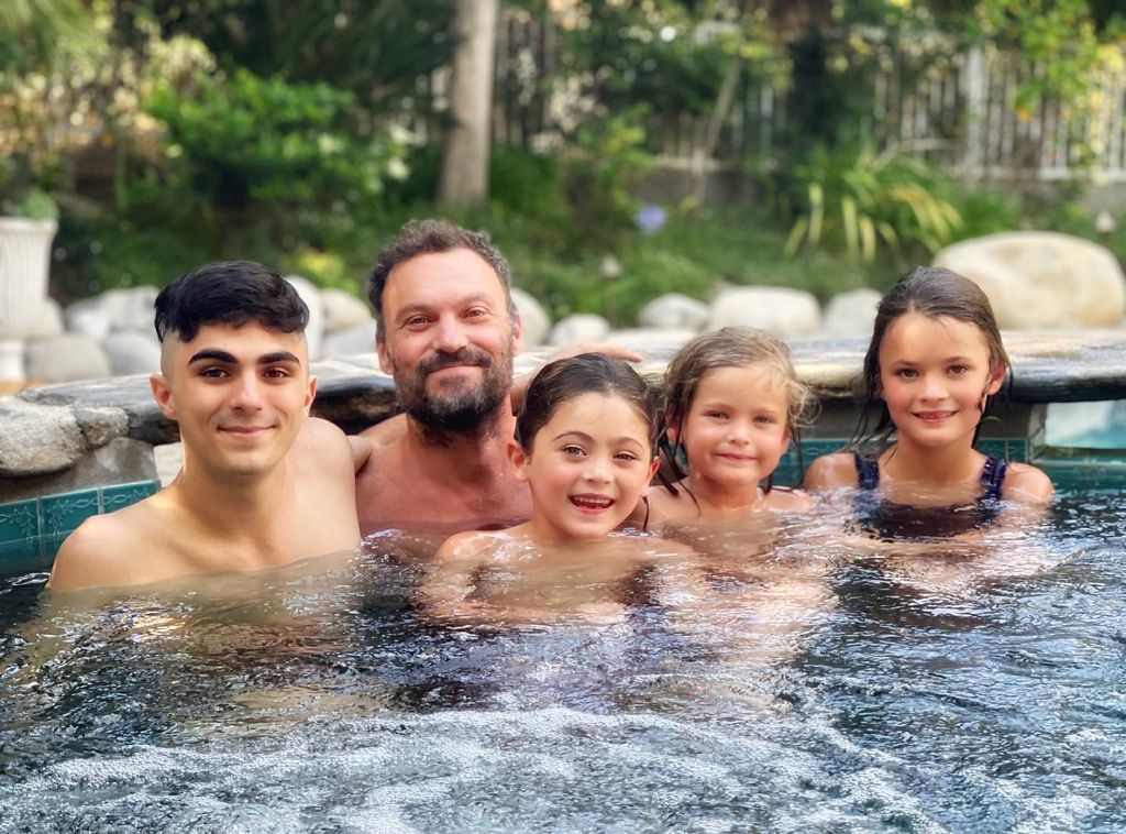 Brian in jacuzzi with four sons