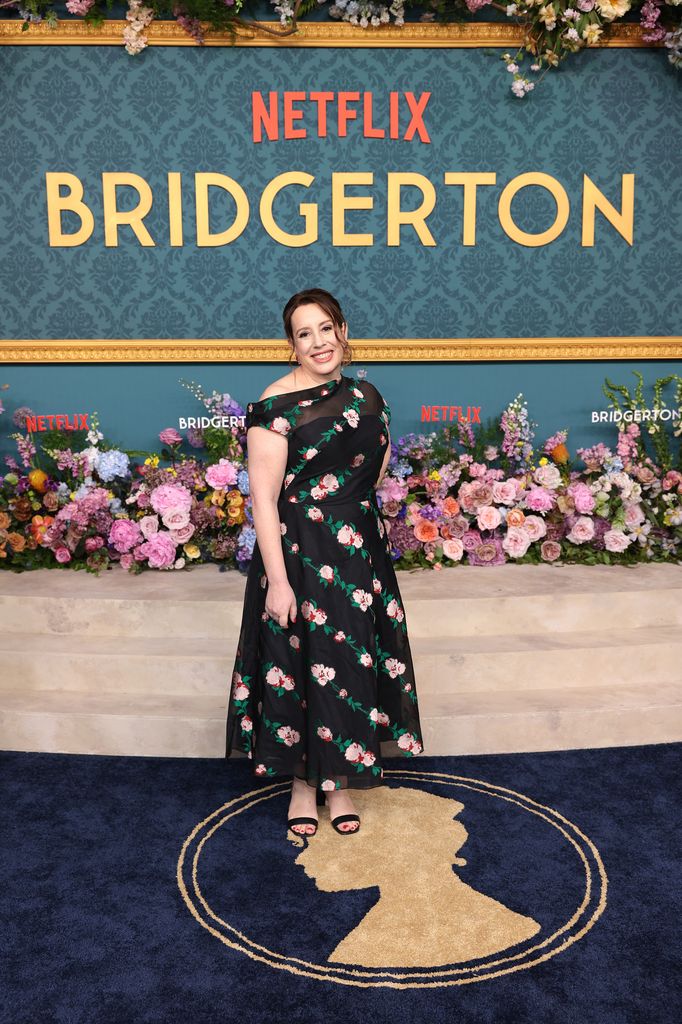 woman posing on red carpet in dress