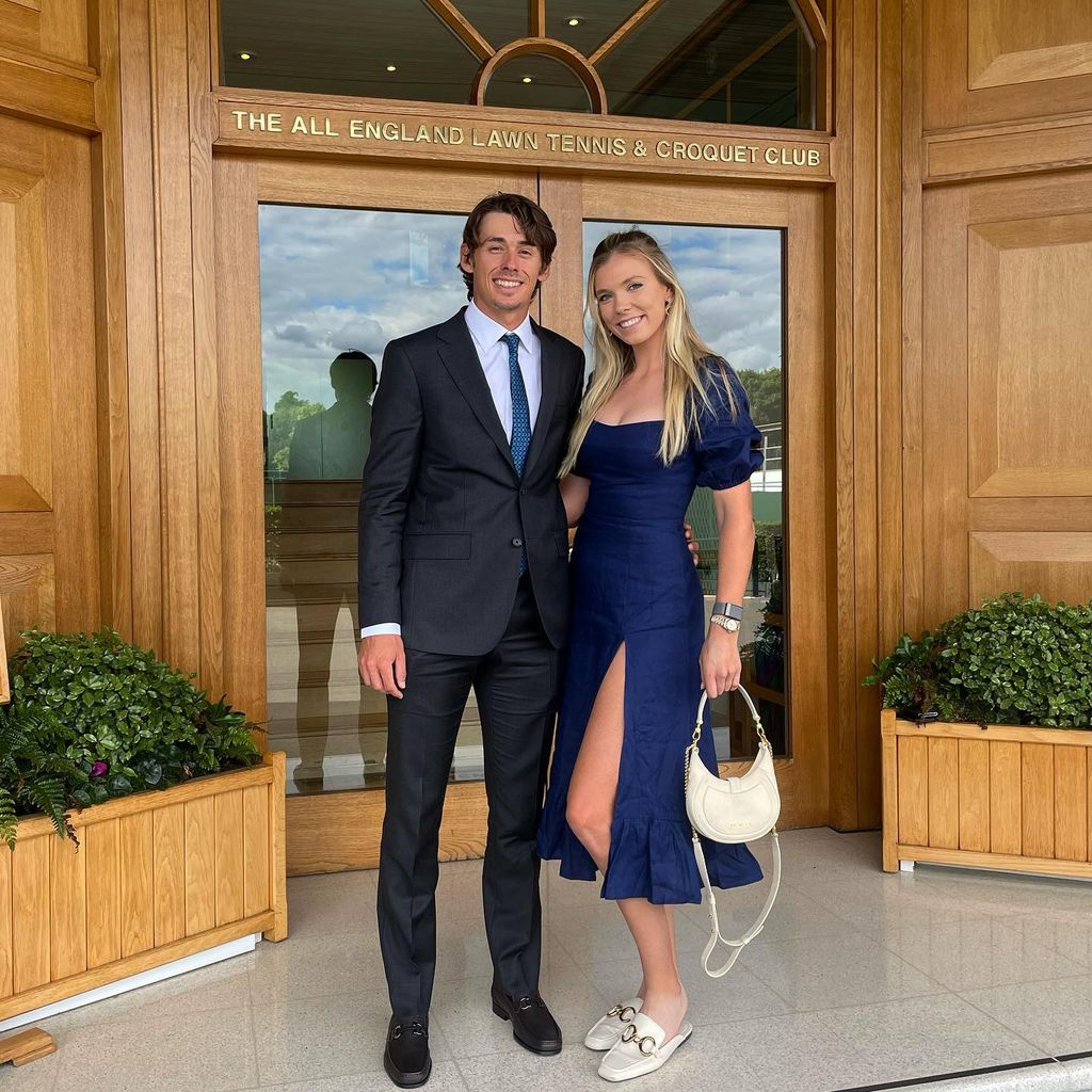 couple looking smart outside tennis club