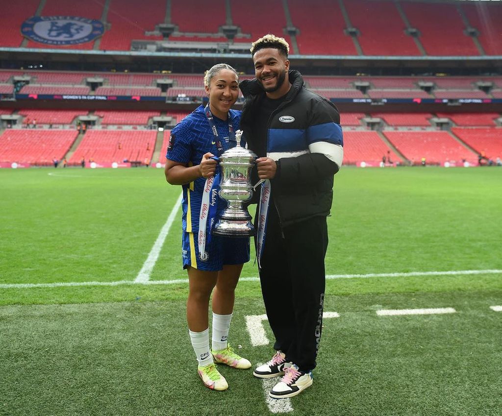 Lauren and Reece James holding a football trophy together