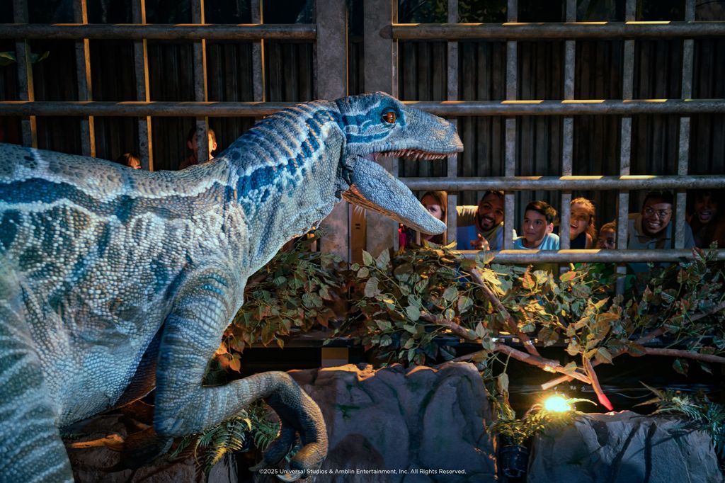 dinosaur in cage with people looking