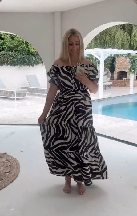 Stacey Solomon's villa-style pool house with stylish archways seen in this mirror selfie as she shows off zebra print dress