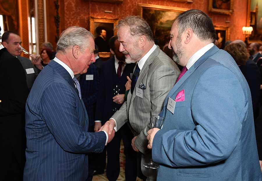 prince charles shakes hand
