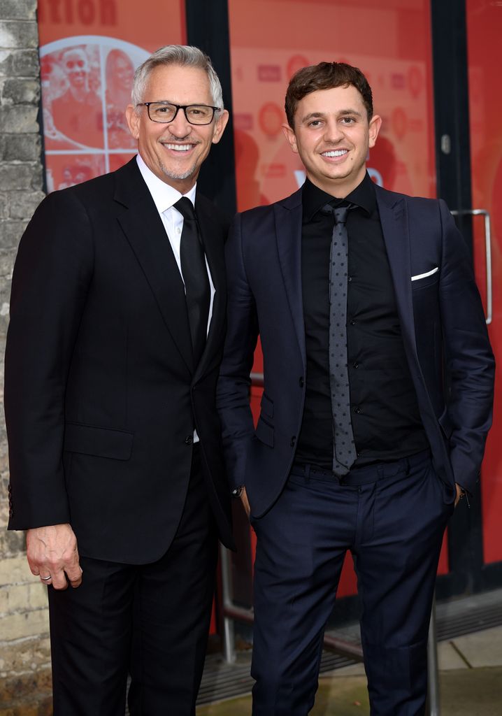 father posing at event with lookalike son