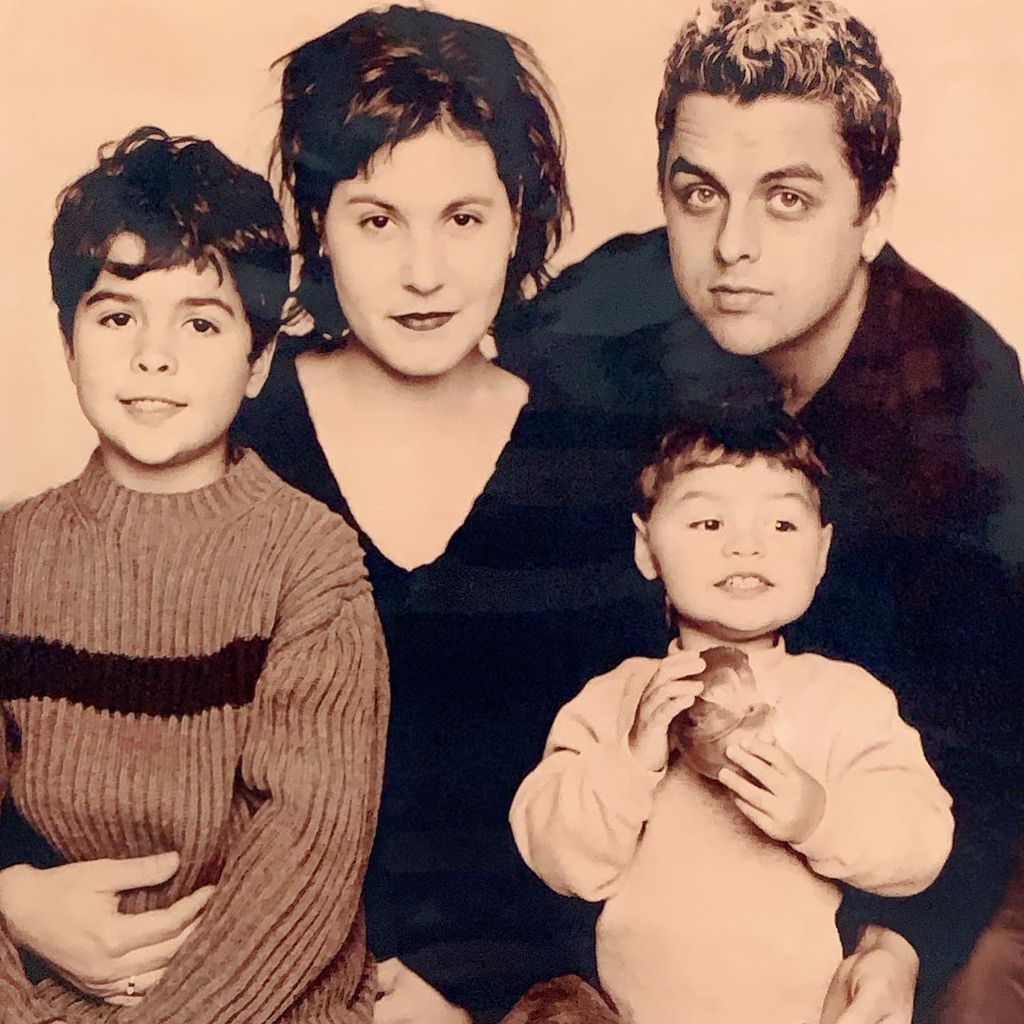 photo of billie joe armstrong and wife with their two children posing for family portrait