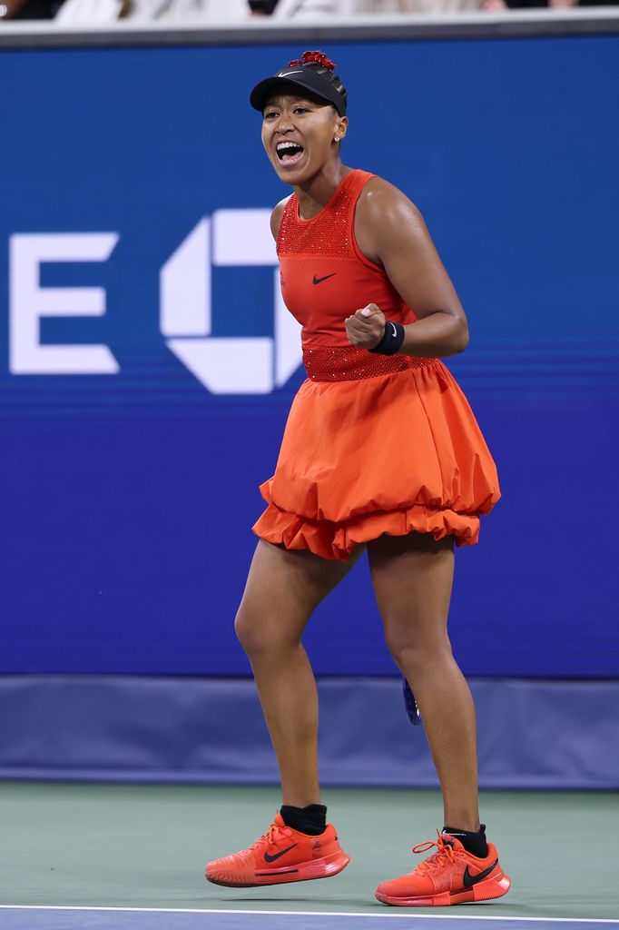 Naomi Osaka celebrates after winning match point against Greet Minnen of Belgium at the 2025 US Open 