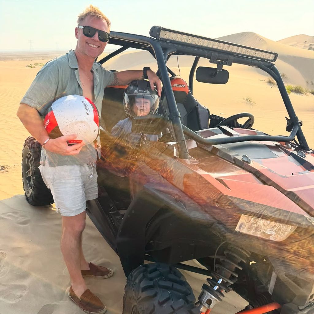 Ronan Keating next to his son in a dune buggy