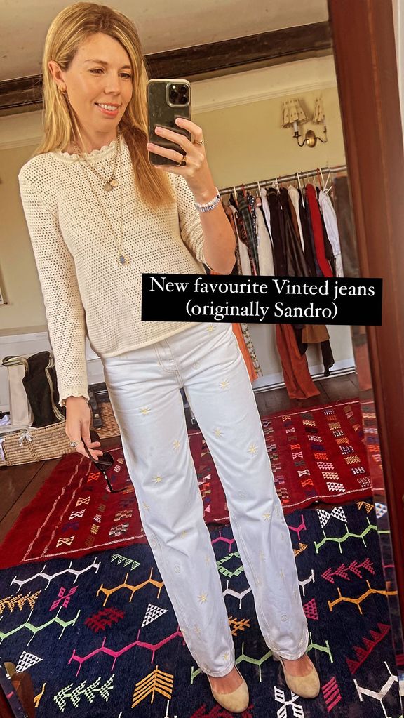 Carrie Johnson wearing a white crocheted top and white jeans 
