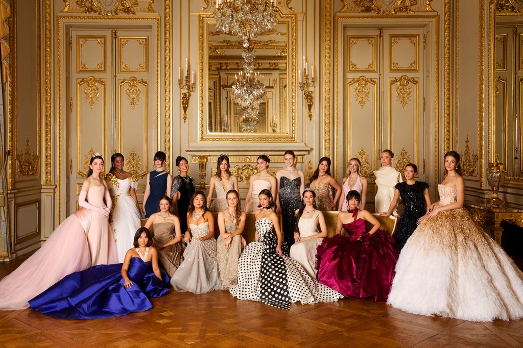 ladies in ball gowns gathered for group photo