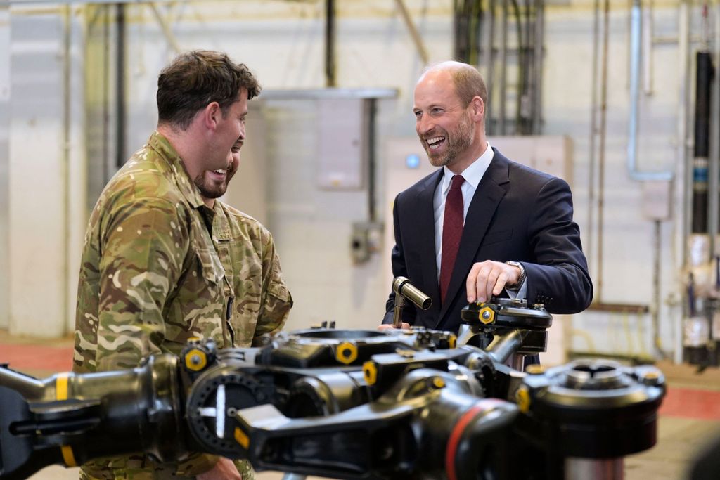 The Prince of Wales (right) helps work on a main rotor head from a chinook helicopter as he meets trainee aircrew and staff from No. 28 (AC) Sqn and No. 22 Sqn during a visit to RAF Benson in Wallingford, Oxfordshire