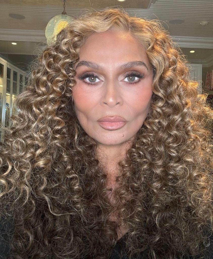 Selfie of tina knowles with glam makeup and curly hair