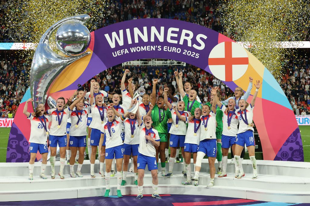 Leah Williamson and Keira Walsh of England lift the UEFA Women's EURO trophy after their team's victory in during the UEFA Women's EURO 2025 Final match between England and Spain