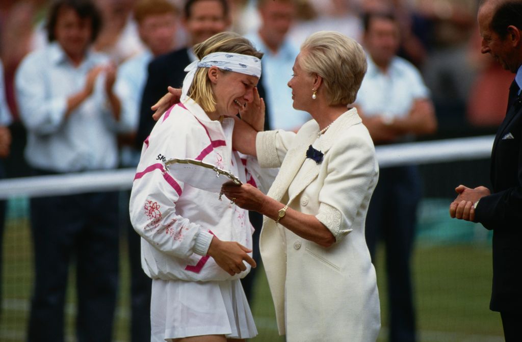 woman consoling tennis player at wimbledon 