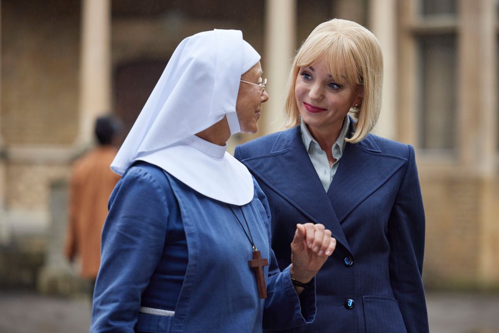 Blonde woman and nun looking at each other