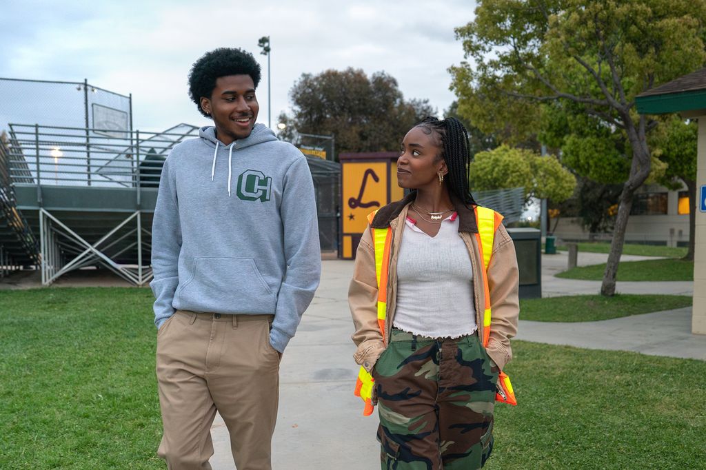 teen boy and girl walking on field