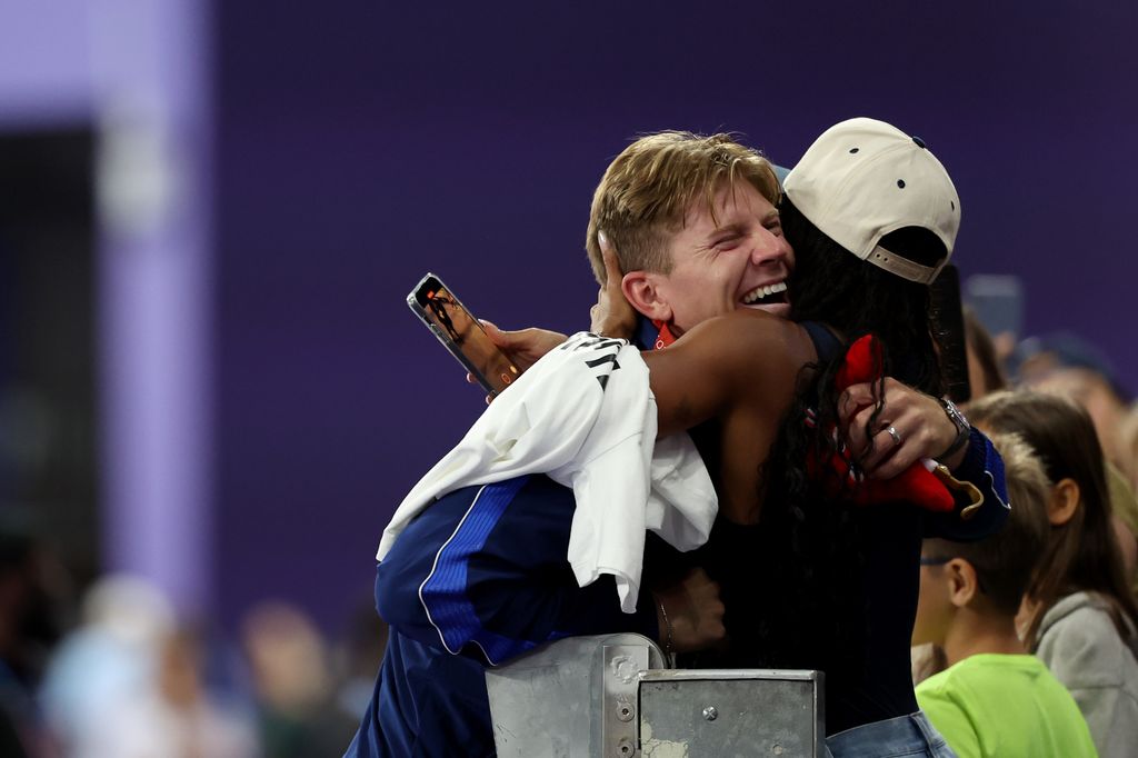 Gold medalist Hunter Woodhall of Team United States celebrates with wife and fellow Olympian Tara Davis-Woodhall