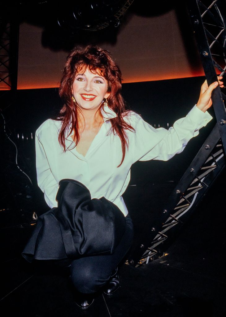 Kate Bush wearing a white relaxed-fit shirt 