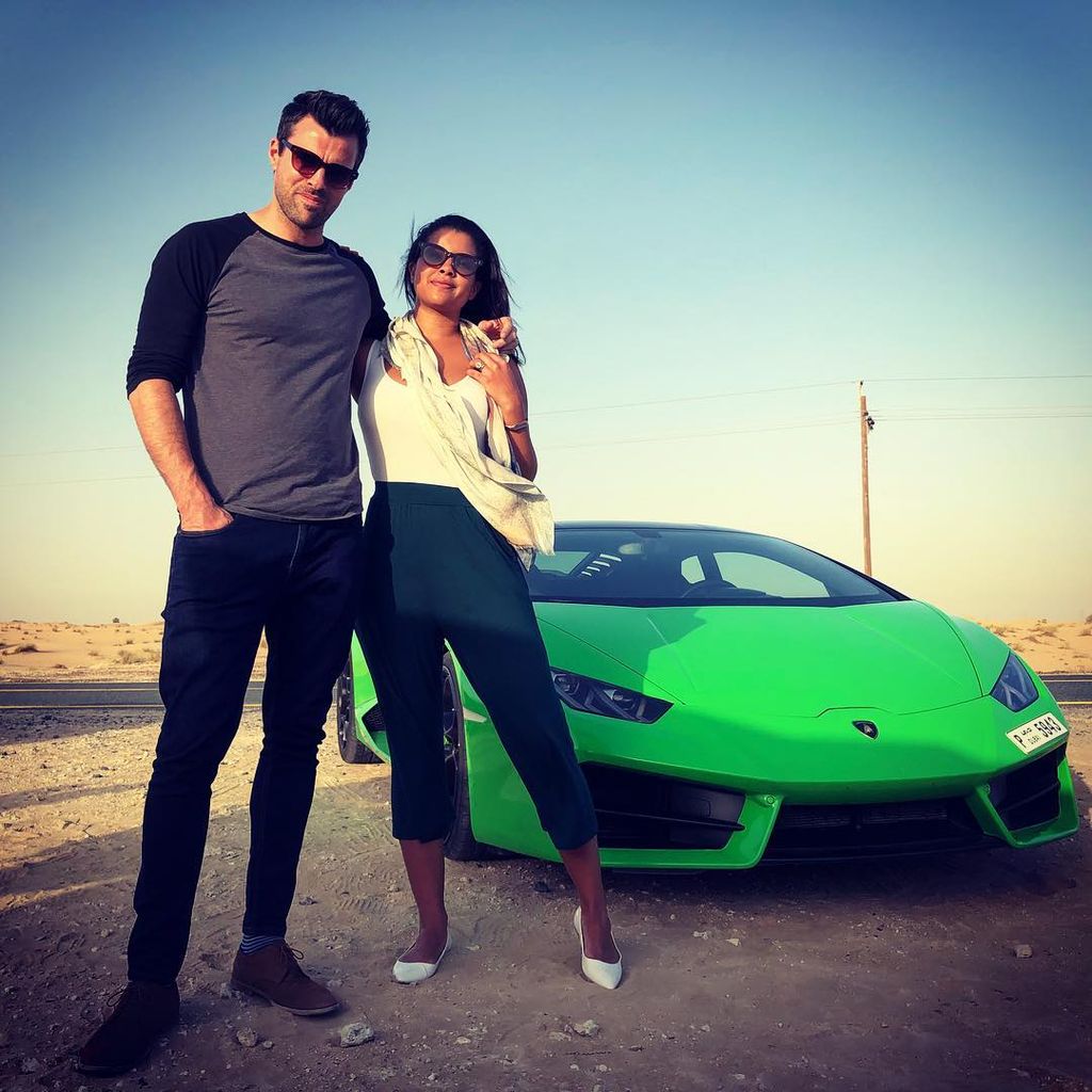 Steve jones and wife by green sports car