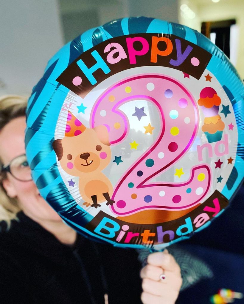 Steph holding a birthday balloon