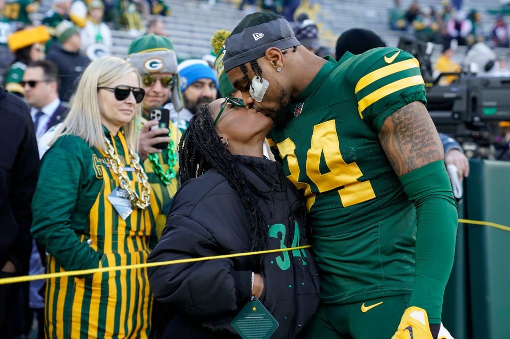 Jonathan Owens #34 of the Green Bay Packers kisses wife Simone Biles before the game against the Los Angeles Chargers at Lambeau Field on November 19, 2023 in Green Bay, Wisconsin.