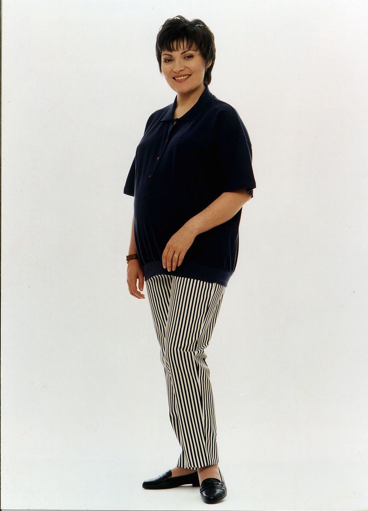 Pregnant Lorraine Kelly in a black shirt and striped trousers