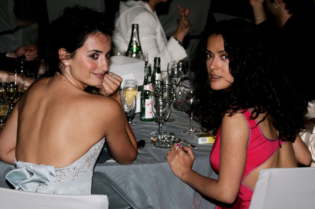 Penélope Cruz and Salma Hayek mingle during the "Cinema Against AIDS 2005" at the 58th Cannes Film Festival on May 19, 2005 in Cannes, France
