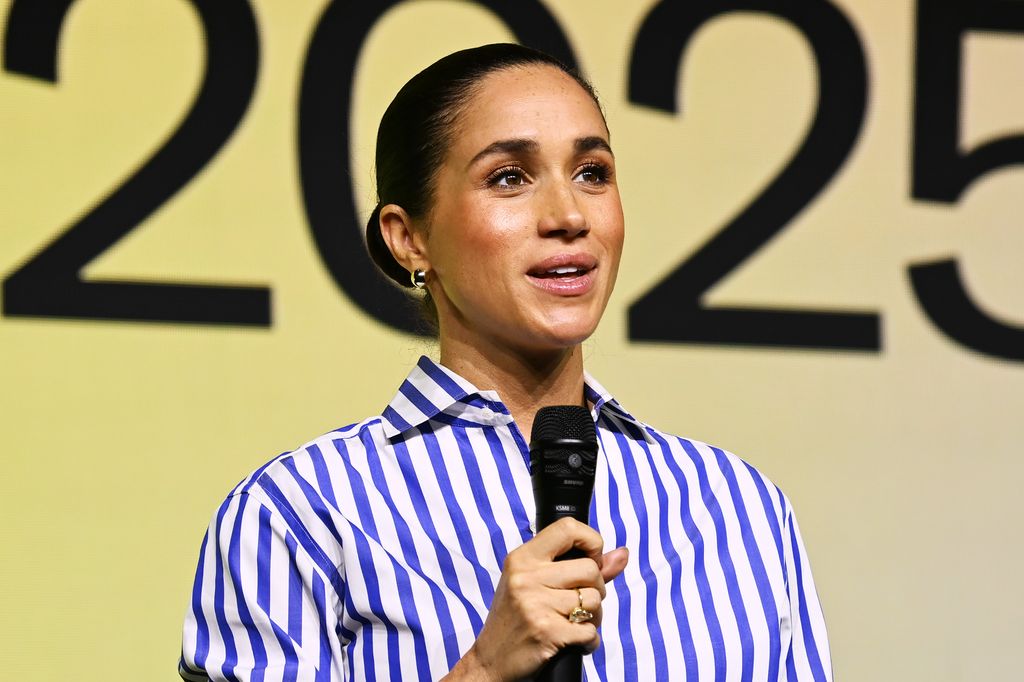 Meghan holding microphone in striped shirt